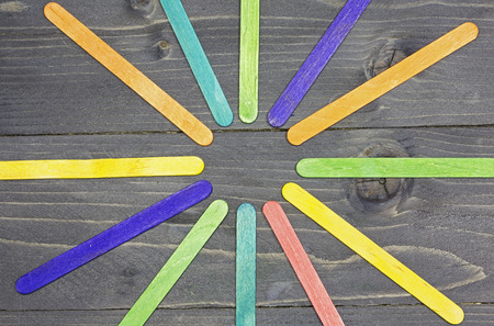 Multi colored rays on gray wooden backgroundの写真素材