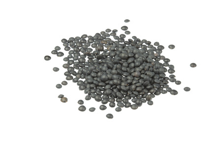 Black lentils pile on white backgroundの写真素材