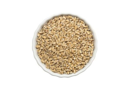 Decorticated spelt ina a ceramic pot on white background