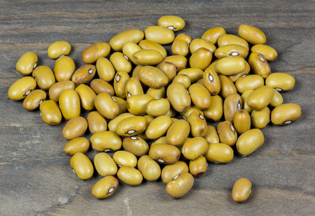 Brown beans  pile isolated on wooden background