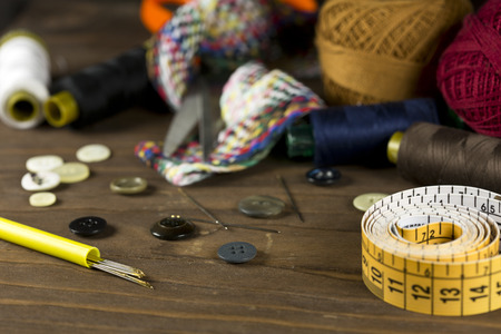 Sewing tools on a wooden background