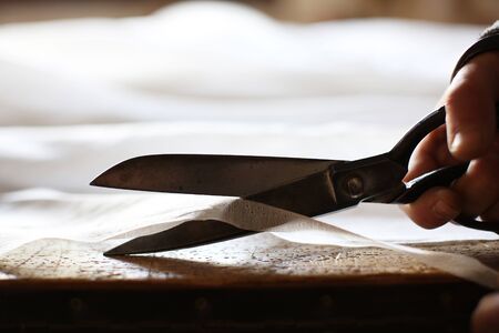 Dressmaker Upholsterer hand with scissorsの写真素材