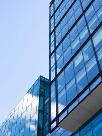 Blue sky and cloud reflection on the windows of an office buildingの写真素材