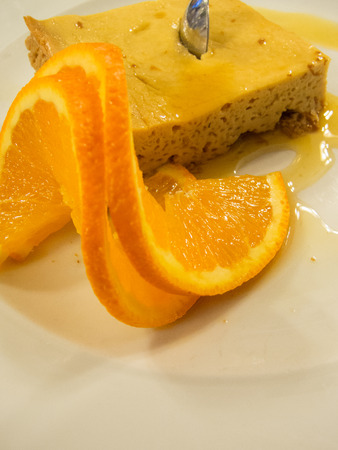 flan and twisted orange slices