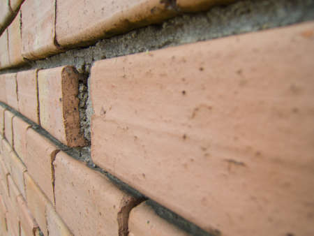 broken brick in a brick wallの写真素材