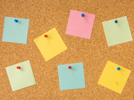cork board seven pinned sticky note filesの写真素材