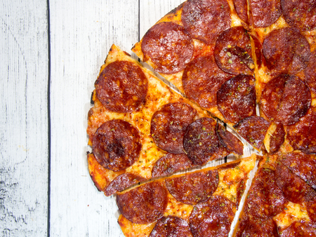 salami pizza on wooden table with copy spaceの写真素材