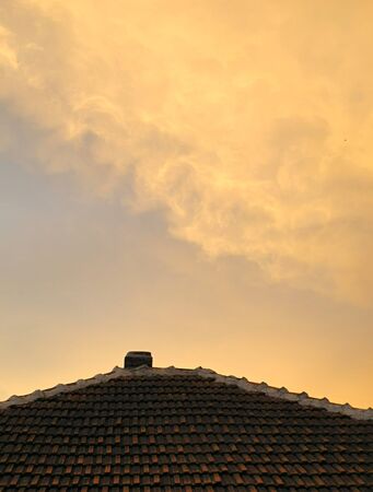 ominous orange sky reflection on the roofの写真素材