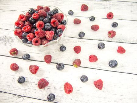 bowl of blueberries and raspberries and fruit spreadの写真素材