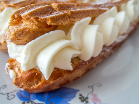 delicious eclairs with vanilla and cream filing