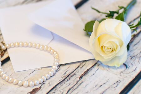 beautiful white rose string of pearls and letter envelope love valentine's day conceptの写真素材