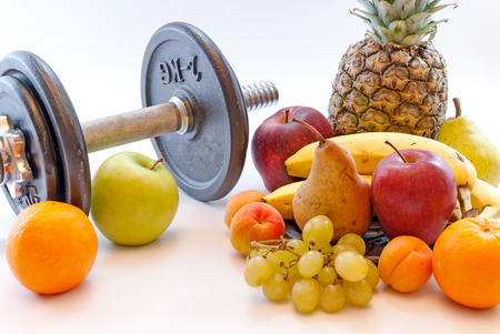 dumbbells and assorted fruits healthy lifestyle weight loss conceptの写真素材