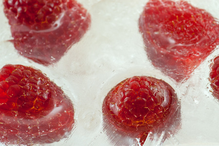 ripe raspberry frozen in ice concept photo