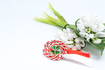 snowdrops and red and white string martisor on white with copy spaceの写真素材