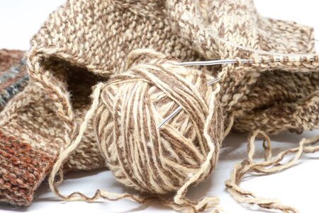 knitting scene of wool vest with brown ball of wool