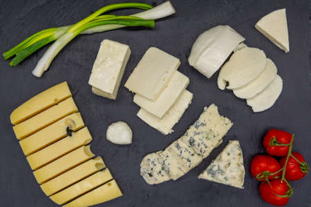 various assorted cheese on black slateの写真素材