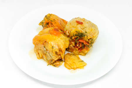 delicious red bell peppers stuffed with minced meat on white plateの写真素材