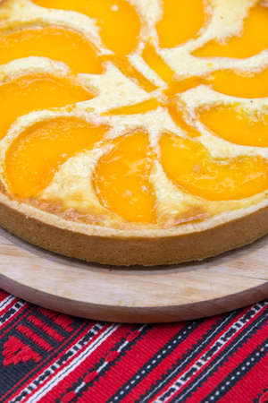 close up delicious peach tart on wood trayの写真素材