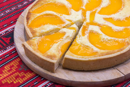 close up delicious peach tart on wood trayの写真素材