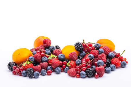 heap of assorted delicious summer fruits on white backgroundの写真素材