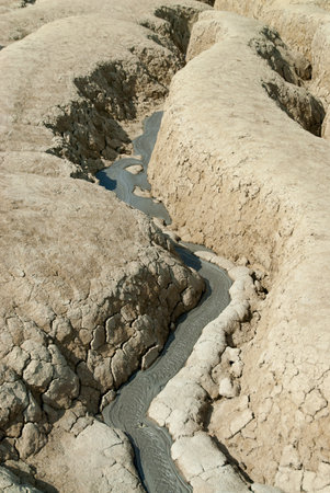 Aerial view of a small river flowing through the rocks in the desert