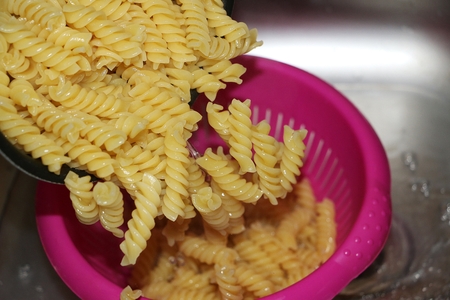noodles are falling in a sieveの写真素材