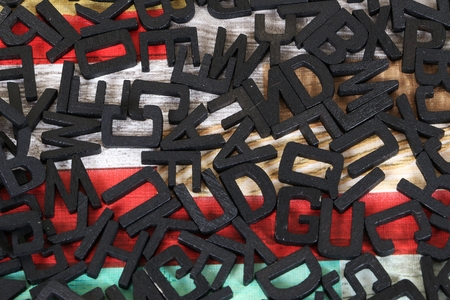 black wooden letters with colorful background in the studioの写真素材