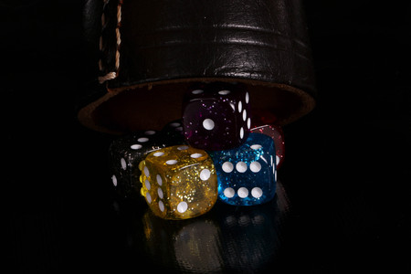 Sparkling dices with a cup in the studioの写真素材