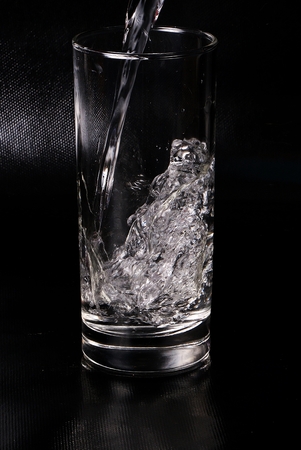 Fresh water is falling in the glassの写真素材