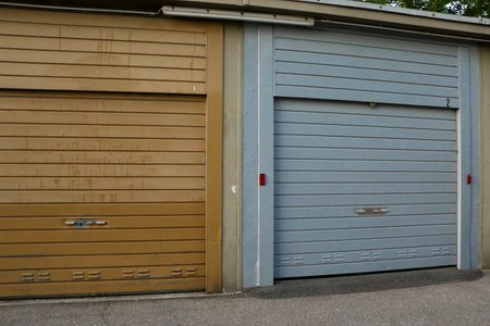 close up of a blue closed garage door in a parking areaの写真素材