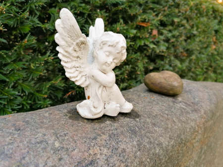 little old angel on a tombstone in the cemeteryの写真素材