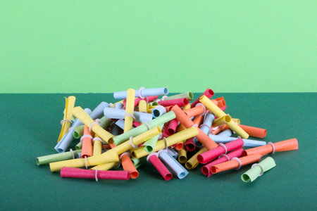 close up of a heap of colorful raffle tickets on a colorful background