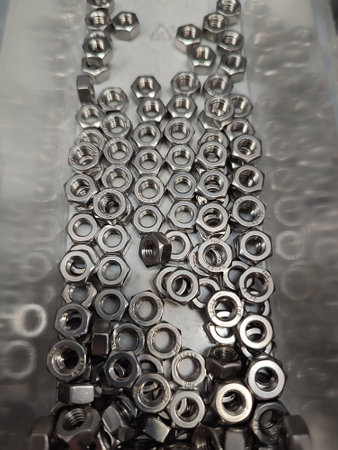 there are a lot of nuts in a plastic container in the workshop