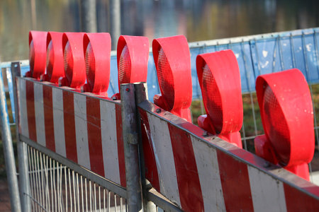 Close-up of a construction site barrier with warning lightsの写真素材