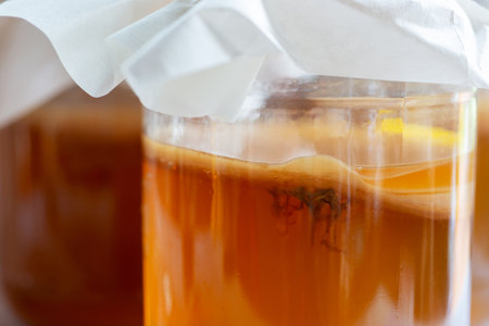 homebrew fermented drink Kombucha in a glass bottle jar, Kombucha SCOBY with yeast  strands...