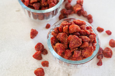 dried strawberry in glass bowl on white table background.