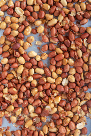 Roasted peanuts on baking tray, food texture  background.