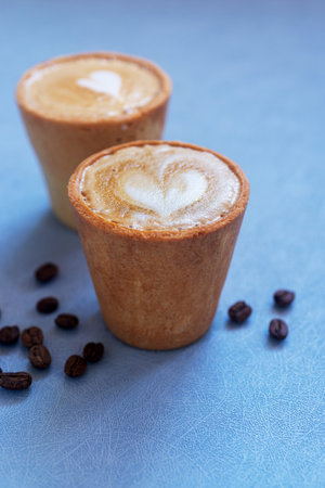 Cafe latte in two edible cookie coffee cup, eco friendly alternative for takeaway cup.の写真素材
