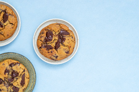 A piece of homemade chocolate chip cookie on ceramic plate.の写真素材