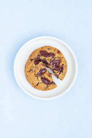 A piece of homemade chocolate chip cookie on ceramic plate.の写真素材