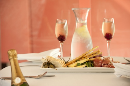 pastry crackers entree with roast beef,prosciutto,rocket and salami and champagneの写真素材