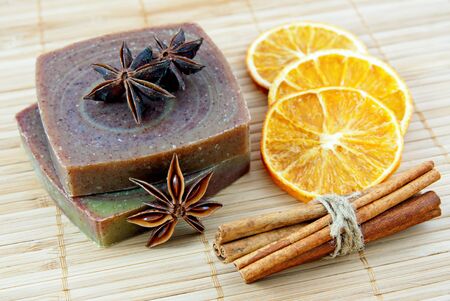 Hand-made soap with orange and cinnamon sticks の写真素材