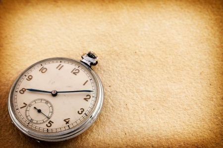 Old pocket watch on vintage paperの写真素材