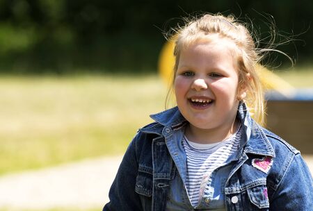 Happy little girl at playgroundの写真素材