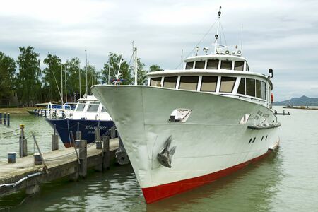 Heviz passenger ship and a police ship in the port of Fonyod at Lake Balaton on 26. April 2018, Hungaryのeditorial素材