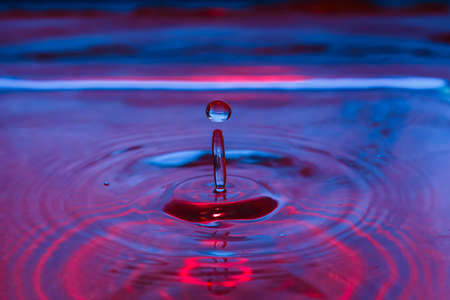 Macro photo of beautiful colorful water splash from fallen drop