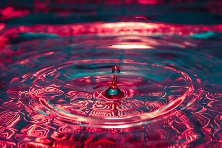 Macro photo of beautiful colorful water splash from fallen drop