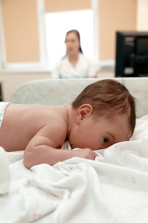 Little newborn baby lying on the table in doctor's  officeの写真素材