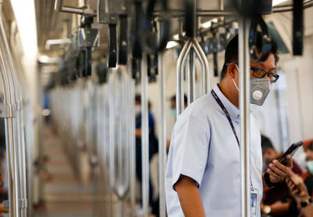 Bangkok, Thailand March 25, 2020. A passengers on a BTS train wear face masks to protect themselves...
