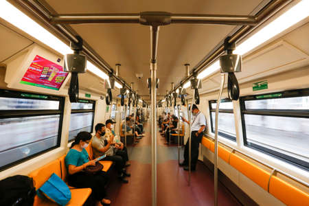 Bangkok, Thailand March 25, 2020. A passengers on a BTS train wear face masks to protect themselves...